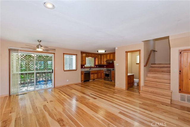 23819 Scenic Dr, Crestline, CA 92325 - unfurnished living room with baseboards, light wood-type flooring, stairs, a sink, and ceiling fan