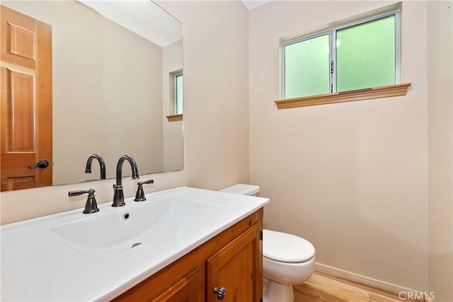 23819 Scenic Dr, Crestline, CA 92325 - half bathroom with toilet, vanity, wood finished floors, and baseboards