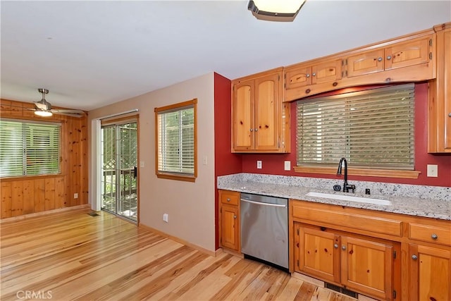 23819 Scenic Dr, Crestline, CA 92325 - kitchen featuring stainless steel dishwasher, a sink, light wood-style floors, a ceiling fan, and light stone countertops