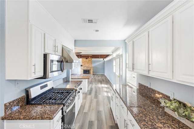 9232 S 7th Ave, Inglewood, CA 90305 - kitchen featuring appliances with stainless steel finishes, light wood-style floors, white cabinetry, and open floor plan