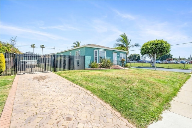 9232 S 7th Ave, Inglewood, CA 90305 - view of front of home with stucco siding, driveway, and a gate