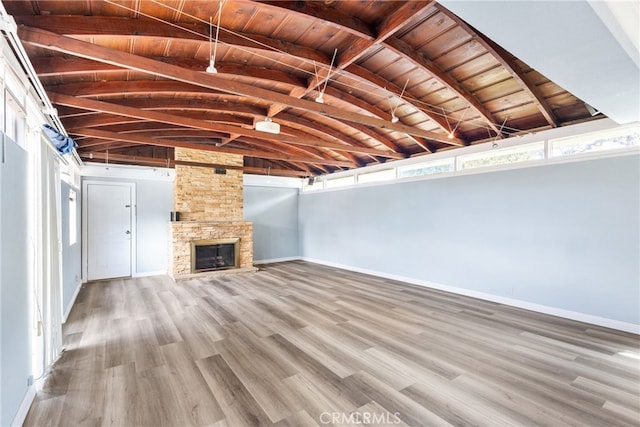 9232 S 7th Ave, Inglewood, CA 90305 - unfurnished living room featuring wooden ceiling, wood finished floors, baseboards, and a stone fireplace