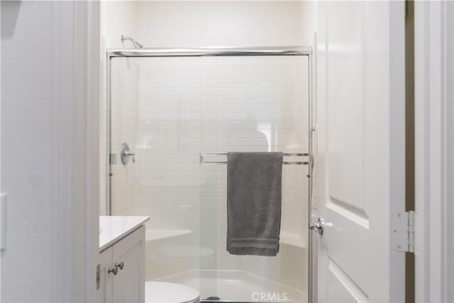 26595 Baneberry Ct, Menifee, CA 92585 - bathroom featuring vanity, a stall shower, toilet, and a textured wall