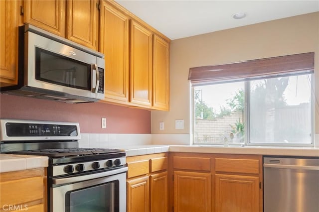 980 Creston Way, Beaumont, CA 92223 - kitchen with stainless steel appliances, tile counters, and a sink