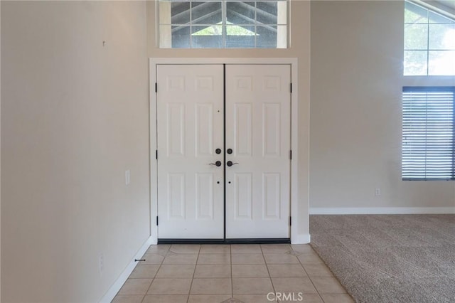 980 Creston Way, Beaumont, CA 92223 - entrance foyer featuring baseboards, light colored carpet, and light tile patterned flooring