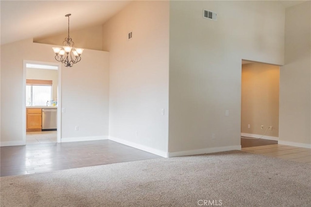 980 Creston Way, Beaumont, CA 92223 - empty room featuring light carpet, a chandelier, high vaulted ceiling, baseboards, and light wood-style flooring