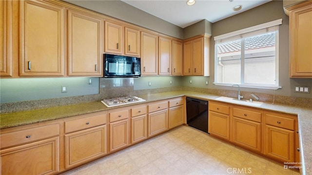 4322 Waterside Ln, Oxnard, CA 93035 - kitchen with black appliances, a sink, light brown cabinetry, light stone counters, and light flooring