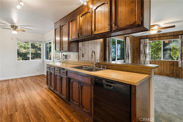 64 Rebie Way, Oroville, CA 95966 - kitchen with black dishwasher, a sink, a ceiling fan, plenty of natural light, and wooden walls