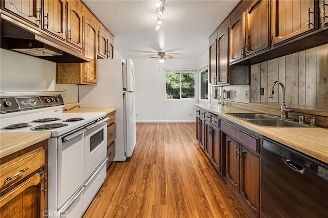 64 Rebie Way, Oroville, CA 95966 - kitchen featuring white appliances, under cabinet range hood, a sink, light wood-type flooring, and light countertops