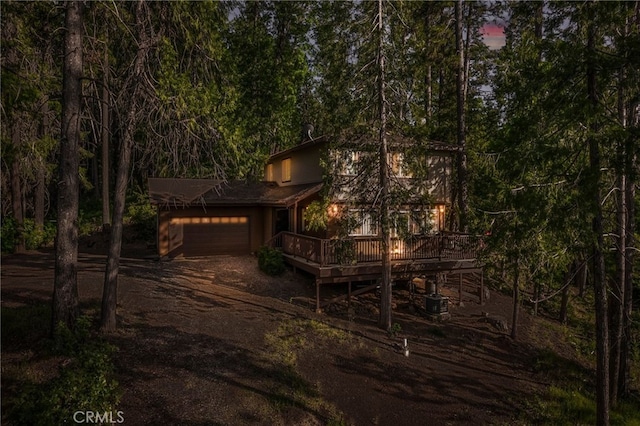 64 Rebie Way, Oroville, CA 95966 - view of front of house with an attached garage, a deck, driveway, and a view of trees