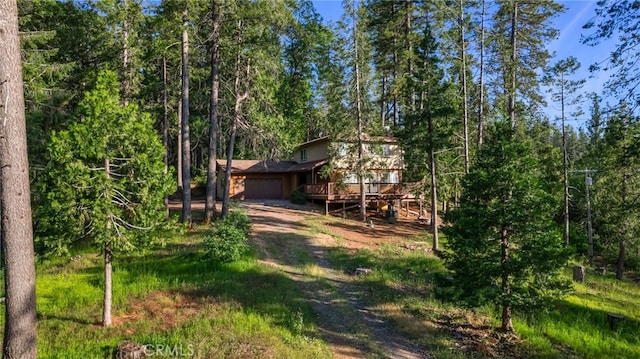 64 Rebie Way, Oroville, CA 95966 - view of yard with an attached garage, a deck, and a wooded view