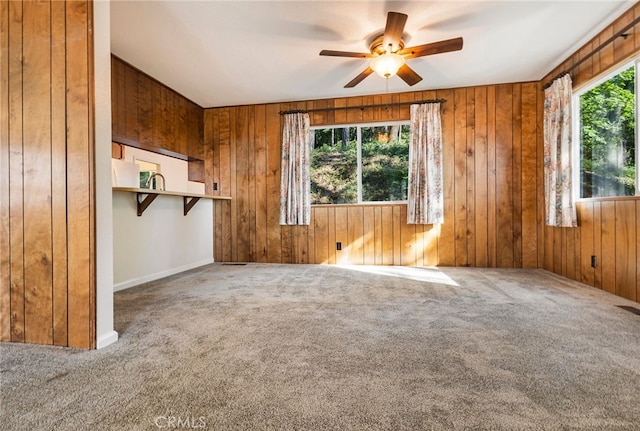 64 Rebie Way, Oroville, CA 95966 - unfurnished living room featuring carpet, a ceiling fan, and wood walls
