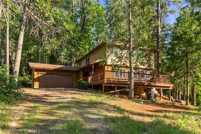 64 Rebie Way, Oroville, CA 95966 - rear view of property with an attached garage, a deck, dirt driveway, and central air condition unit