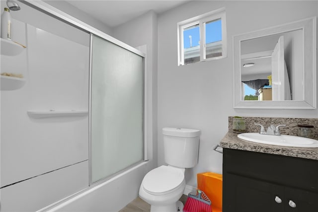 1665 E 84th St, Los Angeles, CA 90001 - full bathroom featuring vanity, toilet, baseboards, and shower / bath combination with glass door