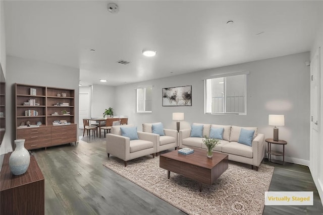 1665 E 84th St, Los Angeles, CA 90001 - living area featuring dark wood-style floors and baseboards