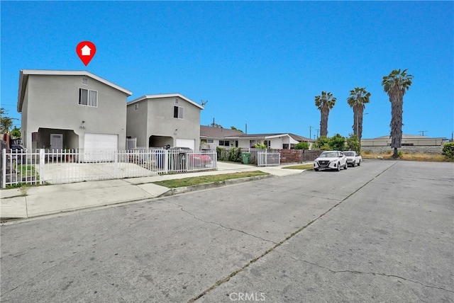 1665 E 84th St, Los Angeles, CA 90001 - view of front of home with stucco siding, a fenced front yard, and a garage