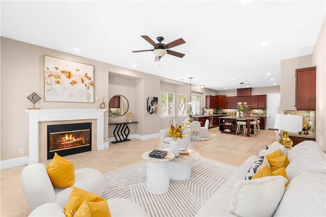 7064 Isle Ct, Rancho Cucamonga, CA 91739 - living area with light tile patterned floors, a ceiling fan, recessed lighting, a fireplace, and baseboards