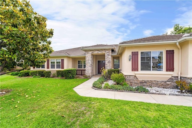 7064 Isle Ct, Rancho Cucamonga, CA 91739 - prairie-style house with stucco siding, a front yard, and stone siding
