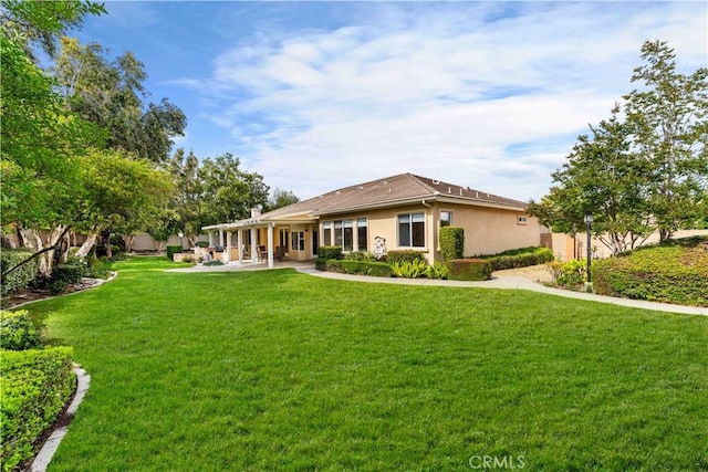 7064 Isle Ct, Rancho Cucamonga, CA 91739 - rear view of house featuring a yard, stucco siding, and a patio