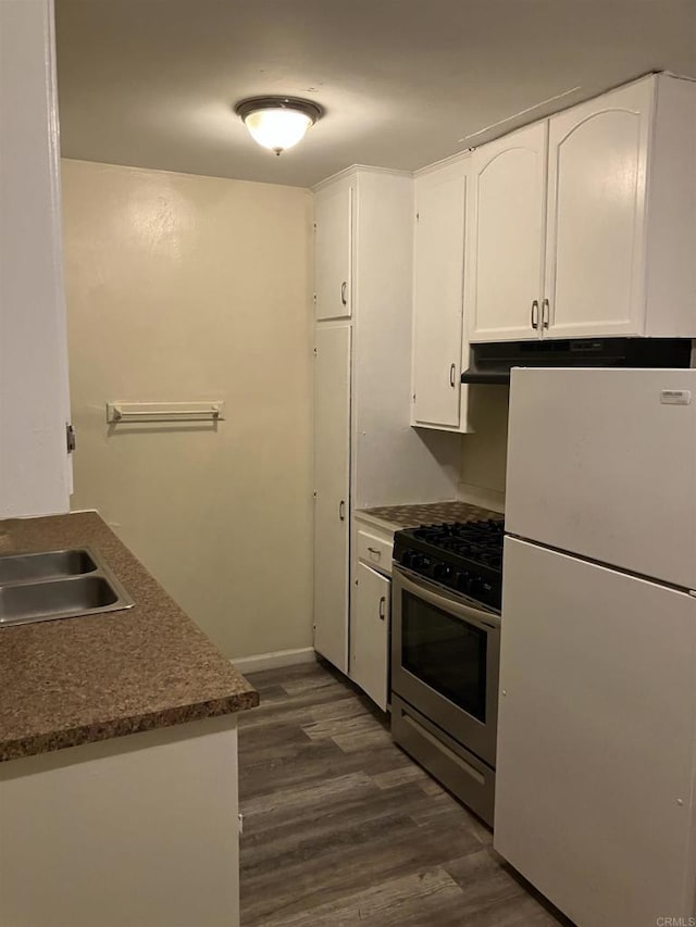 386771 Menlo Ave, San Diego, CA 92105 - kitchen with freestanding refrigerator, stainless steel gas range oven, dark wood-type flooring, white cabinetry, and a sink