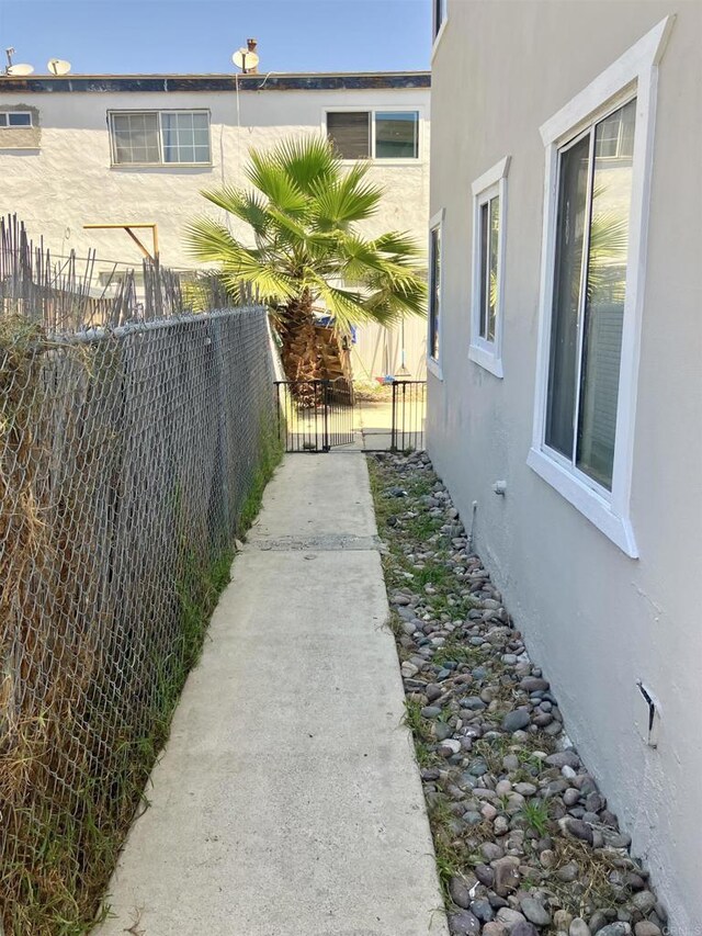 386771 Menlo Ave, San Diego, CA 92105 - view of side of property featuring stucco siding and a gate