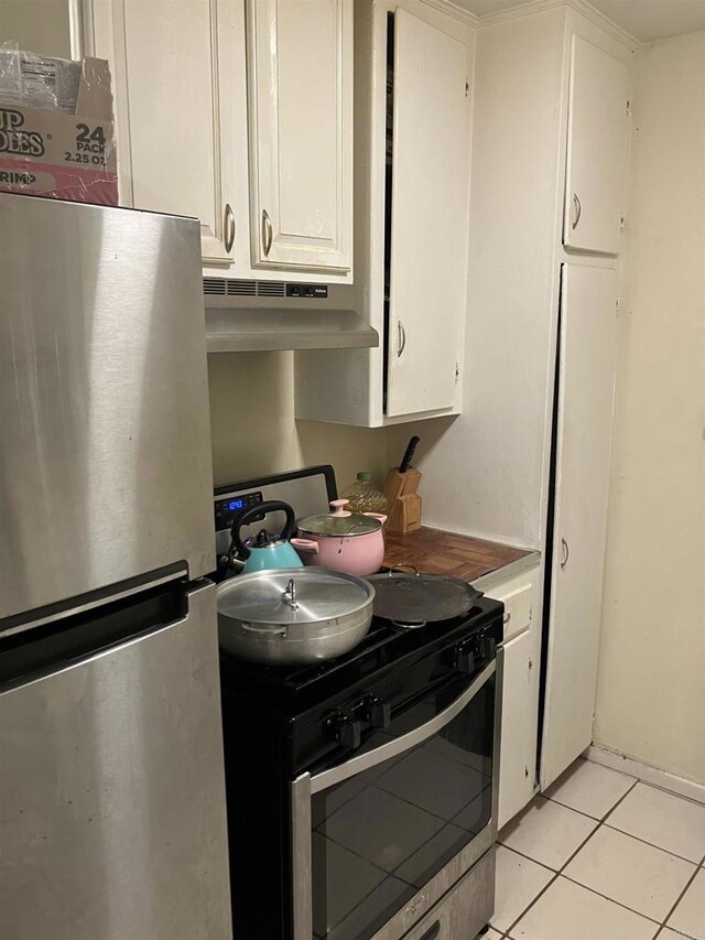 386771 Menlo Ave, San Diego, CA 92105 - kitchen featuring stainless steel appliances, under cabinet range hood, white cabinetry, and light tile patterned flooring