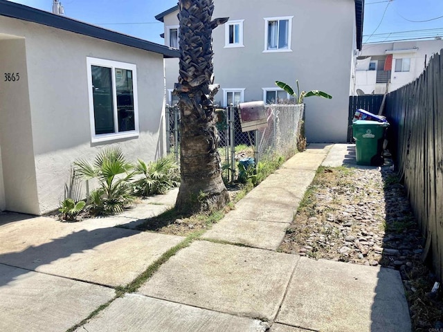 386771 Menlo Ave, San Diego, CA 92105 - view of side of property featuring stucco siding and a fenced backyard