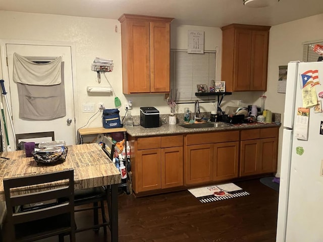 386771 Menlo Ave, San Diego, CA 92105 - kitchen with freestanding refrigerator, dark wood-type flooring, brown cabinets, and a sink