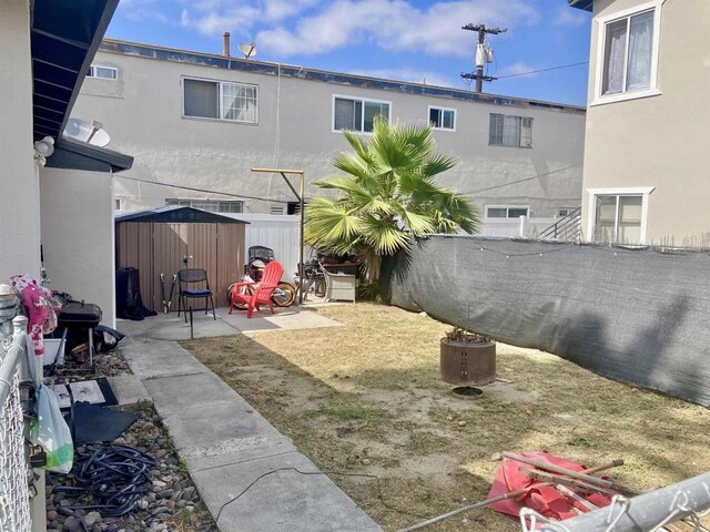 386771 Menlo Ave, San Diego, CA 92105 - fenced backyard featuring a storage shed and a patio area