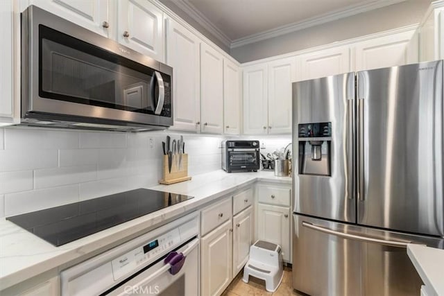 23402 Brookdale Ln Unit 56, Valencia, CA 91355 - kitchen with appliances with stainless steel finishes, white cabinets, ornamental molding, decorative backsplash, and light stone counters