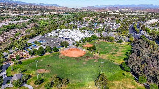 23402 Brookdale Ln Unit 56, Valencia, CA 91355 - aerial view of property's location featuring a mountain backdrop, nearby suburban area, and a golf club