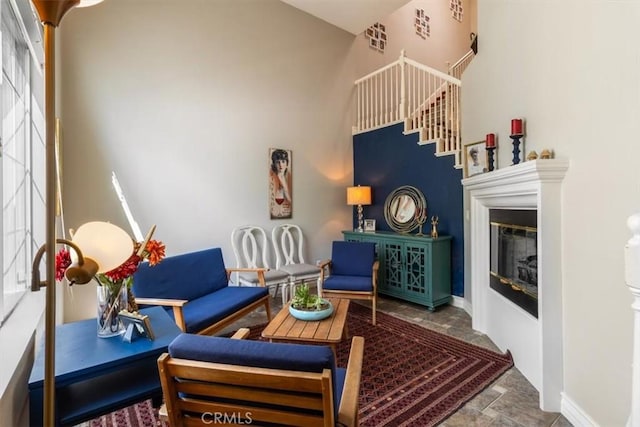 23402 Brookdale Ln Unit 56, Valencia, CA 91355 - living area with a glass covered fireplace, stone finish floors, and a towering ceiling