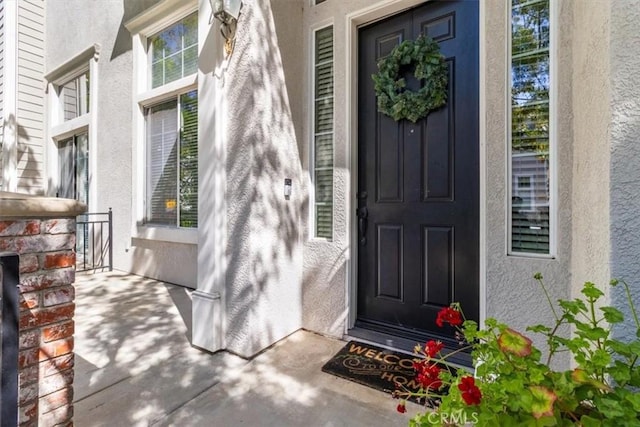 23402 Brookdale Ln Unit 56, Valencia, CA 91355 - doorway to property featuring stucco siding and covered porch