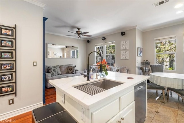 23402 Brookdale Ln Unit 56, Valencia, CA 91355 - kitchen featuring stainless steel dishwasher, ceiling fan, light stone counters, open floor plan, and ornamental molding