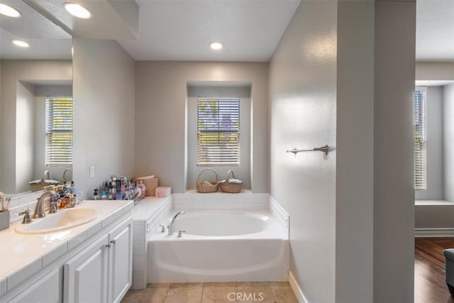 23402 Brookdale Ln Unit 56, Valencia, CA 91355 - full bathroom with vanity, a bath, healthy amount of natural light, and recessed lighting