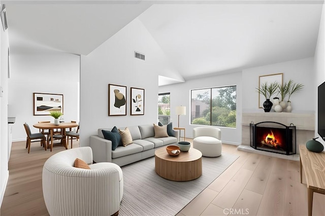 659 Valley Oak Ln, Newbury Park, CA 91320 - living room with wood finished floors, a lit fireplace, and high vaulted ceiling