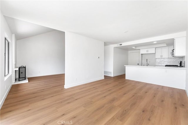 659 Valley Oak Ln, Newbury Park, CA 91320 - unfurnished living room with baseboards, light wood-style floors, a sink, and recessed lighting