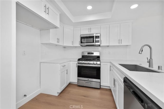 659 Valley Oak Ln, Newbury Park, CA 91320 - kitchen featuring appliances with stainless steel finishes, a sink, light countertops, decorative backsplash, and recessed lighting