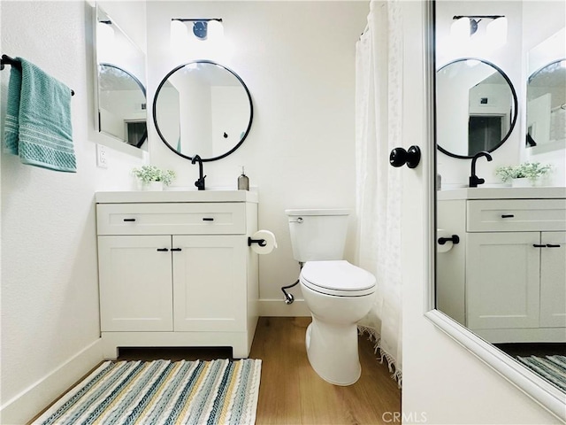 659 Valley Oak Ln, Newbury Park, CA 91320 - full bathroom with wood finished floors, vanity, toilet, and baseboards