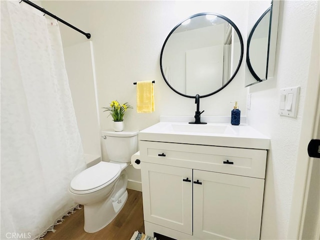 659 Valley Oak Ln, Newbury Park, CA 91320 - bathroom featuring wood finished floors, vanity, toilet, shower / bath combo with shower curtain, and baseboards