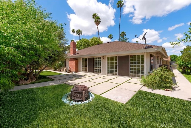 4950 Via Campeche, Riverside, CA 92507 - rear view of house with a patio, a fire pit, a chimney, and a lawn