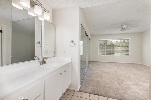 4950 Via Campeche, Riverside, CA 92507 - bathroom featuring a textured ceiling, ceiling fan, vanity, tile patterned flooring, and baseboards