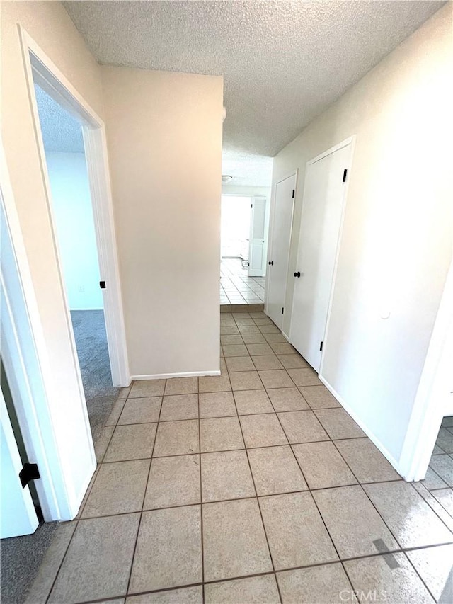 4950 Via Campeche, Riverside, CA 92507 - hall with light tile patterned floors and a textured ceiling