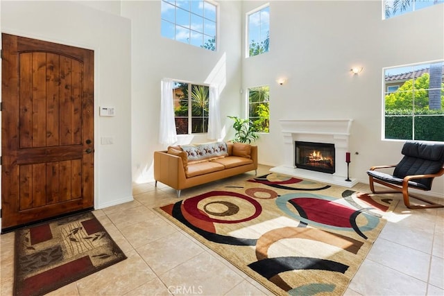7659 Balasiano Ave, West Hills, CA 91304 - entrance foyer with a towering ceiling, healthy amount of natural light, tile patterned floors, and a warm lit fireplace