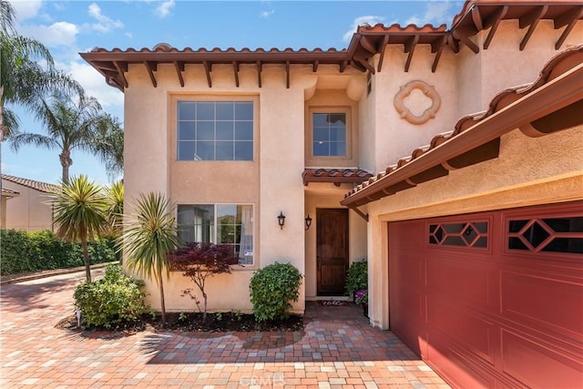 7659 Balasiano Ave, West Hills, CA 91304 - mediterranean / spanish-style house featuring a tile roof, stucco siding, and a garage