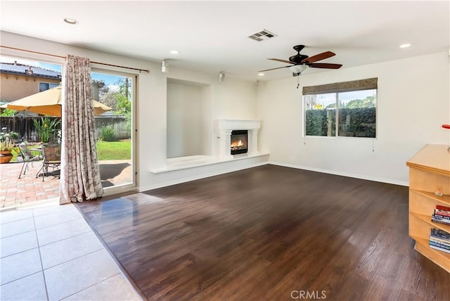7659 Balasiano Ave, West Hills, CA 91304 - unfurnished living room featuring wood finished floors, a glass covered fireplace, baseboards, recessed lighting, and ceiling fan