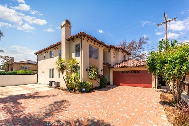 7659 Balasiano Ave, West Hills, CA 91304 - mediterranean / spanish home with a chimney, stucco siding, a tiled roof, a garage, and decorative driveway