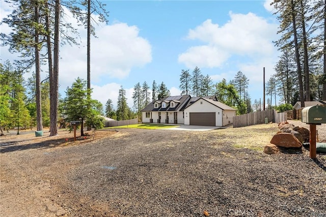 5755 Fickett Ln, Paradise, CA 95969 - view of front facade with solar panels, driveway, an attached garage, and stucco siding