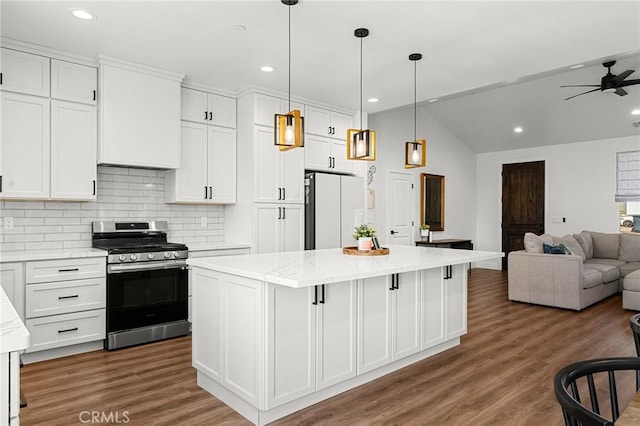 5755 Fickett Ln, Paradise, CA 95969 - kitchen with gas stove, freestanding refrigerator, open floor plan, a center island, and decorative backsplash