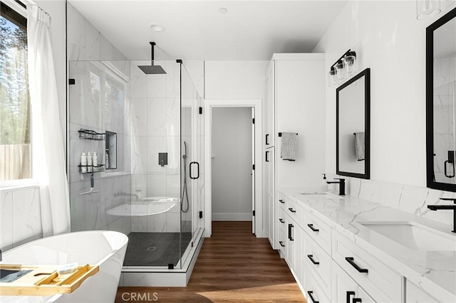 5755 Fickett Ln, Paradise, CA 95969 - full bath with a stall shower, a freestanding tub, double vanity, wood finished floors, and baseboards